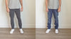 A side-by-side comparison of two men wearing different jeans. The man on the left is wearing gray jeans for short men that fit perfectly and a light gray t-shirt, while the man on the right is wearing baggy loose ill fitting blue jeans and a light gray t-shirt. Both are standing indoors against a white wall and wearing white shoes.